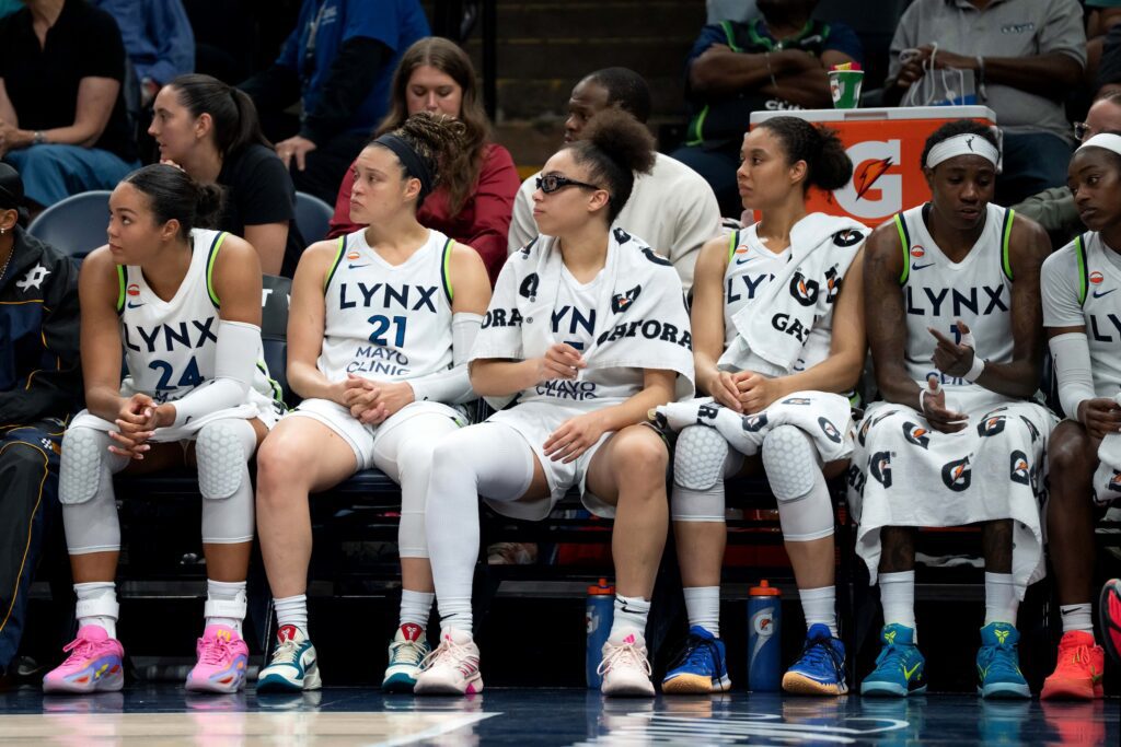 Minnesota Lynx forward Napheesa Collier (24) guard Kayla McBride (21), guard Olivia Miles (5), forward Nia Coffey (12), and forward Natasha Howard (1) sit on the bench against the Golden State Valkyries in the second half at Target Center.