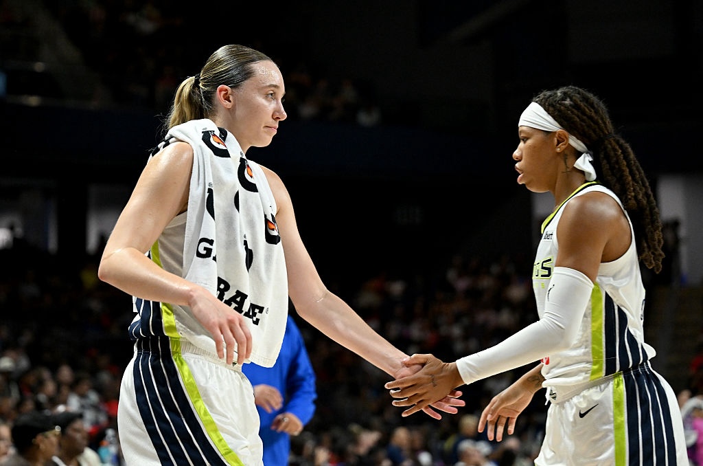 Paige Bueckers #5 of the Dallas Wings celebrates with Sug Sutton #0 during the game against the Washington Mystics.