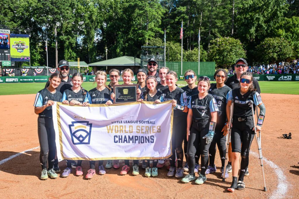 Johnston County Little League pose with 2026 Championship banner.