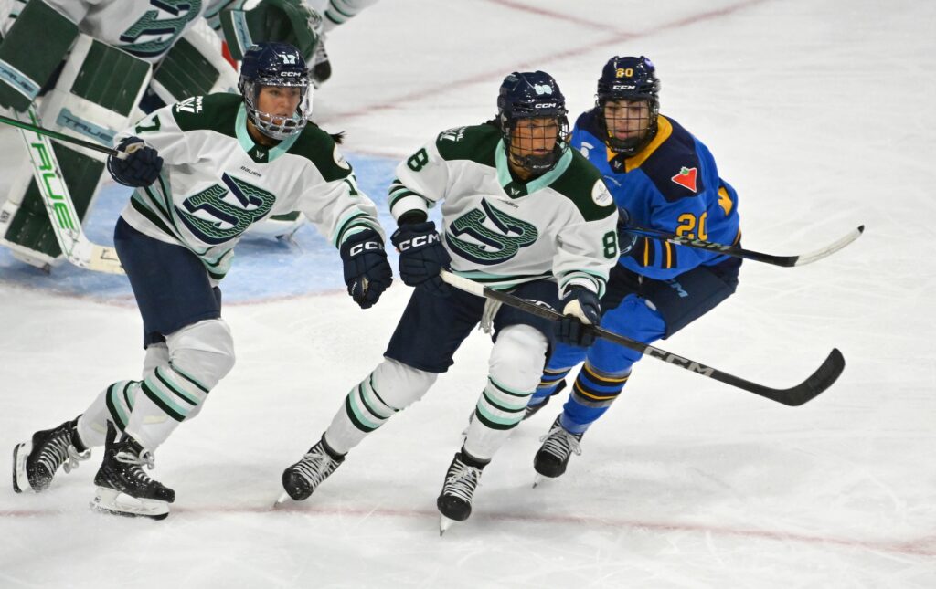 Boston Fleet forwards Lexie Adzija (88) and Taylor Girard (17) pursue the play against Toronto Sceptres forward Sarah Nurse (20) in the third period at Coca-Cola Coliseum.