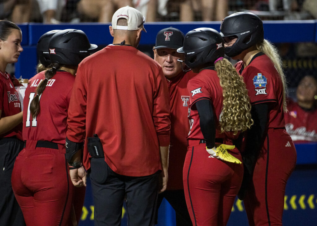 Texas Tech Red Raiders head coach Gerry Glasco talks to his player during a timeout in the third inning against the Alabama Crimson Tide during the NCAA Women’s College softball World Series at Devon Park.