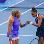 Serena Williams and her sister, Venus Williams, bump fists during a doubles match at the Cincinnati Open at the Lindner Family Tennis Center in Mason on Aug. 17, 2026. The sisters fell to Marta Kostyuk and Peyton Stearns, 6-2, 1-6, 10-8.