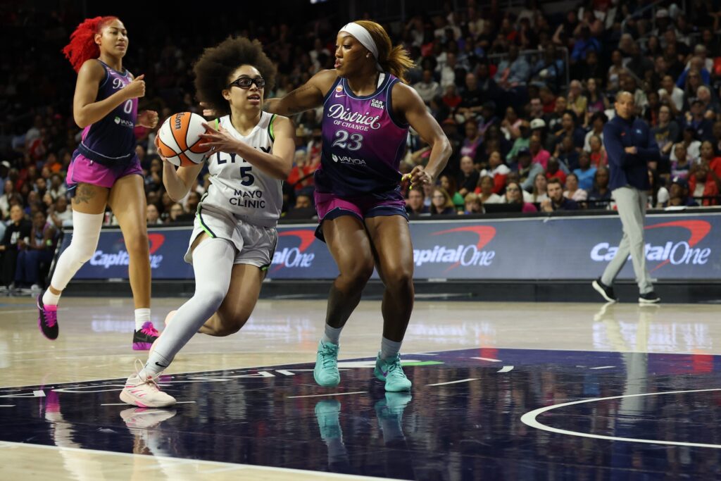 Minnesota Lynx guard Olivia Miles (5) drives to the basket as Washington Mystics guard Cotie McMahon (23) defends in the second half at CareFirst Arena.
