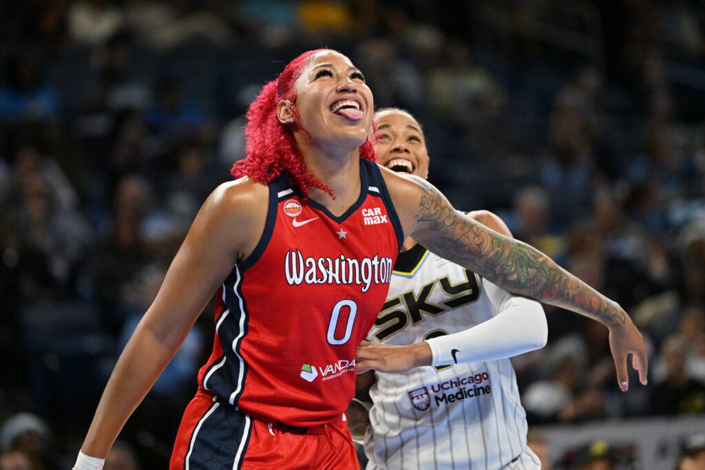 Washington Mystics center Shakira Austin (0) sticks her tongue out while next to Chicago Sky guard Natasha Cloud (9) during the first half at the Wintrust Arena.