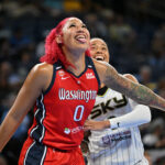 Washington Mystics center Shakira Austin (0) sticks her tongue out while next to Chicago Sky guard Natasha Cloud (9) during the first half at the Wintrust Arena.