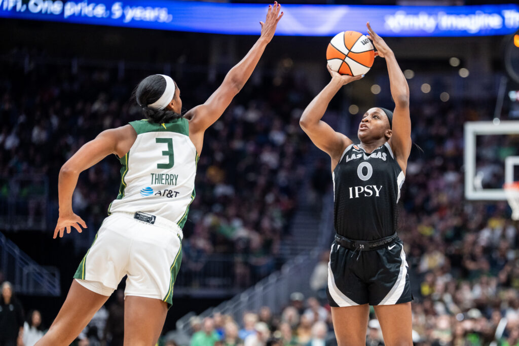 Las Vegas Aces guard Jackie Young (0) shoots the ball gainst Seattle Storm forward Taylor Thierry (3) during the second half at Climate Pledge Arena.
