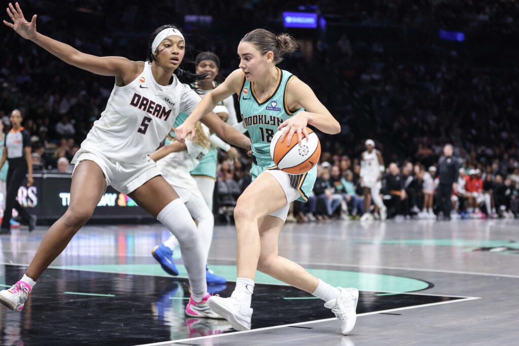Sep 21, 2026; Brooklyn, New York, USA; New York Liberty guard Pauline Astier (18) drives past Atlanta Dream forward Angel Reese (5) in the fourth quarter at Barclays Center