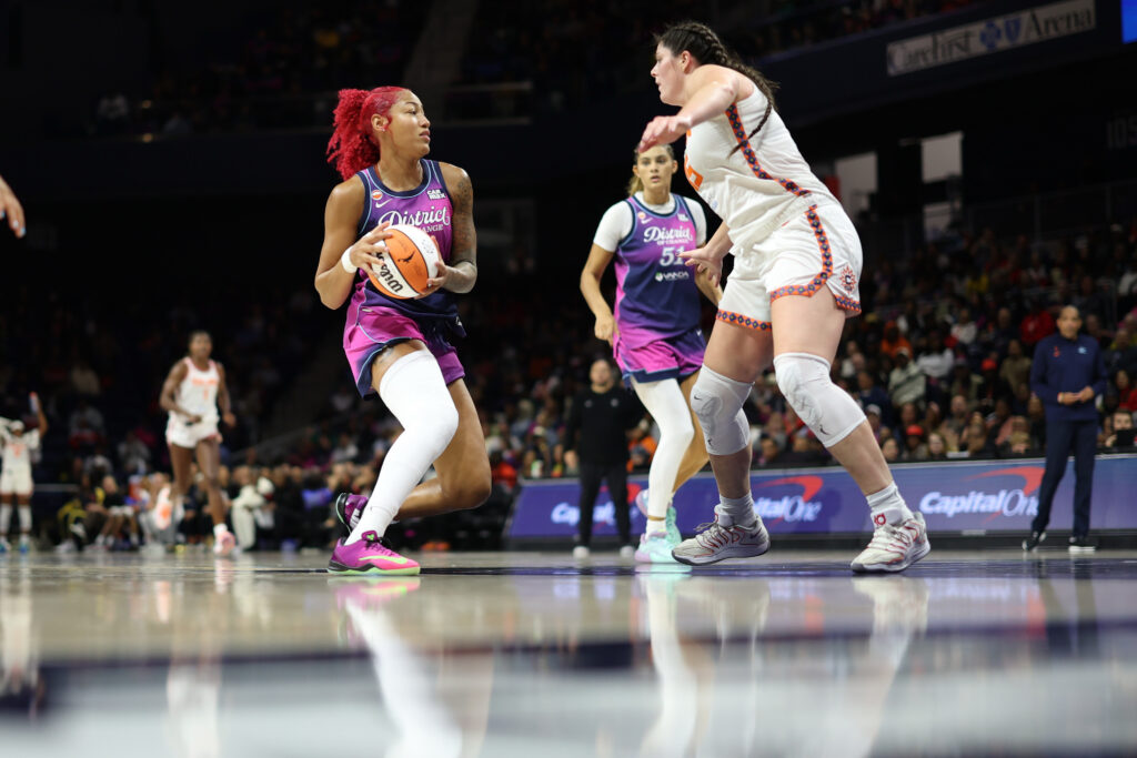 Washington Mystics center Shakira Austin (0) drives to the basket as Connecticut Sun forward Raegan Beers (15) defends in the first half at CareFirst Arena.