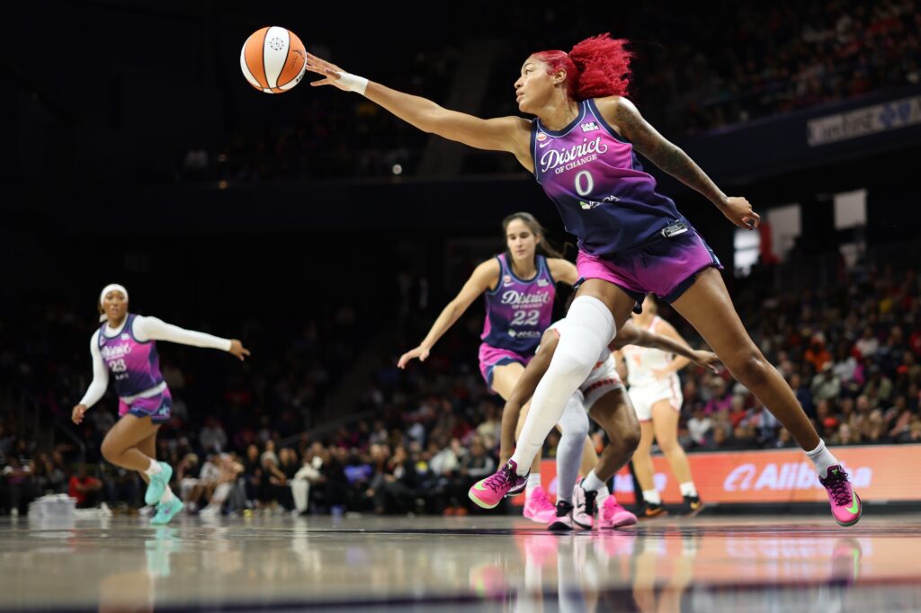 Washington Mystics center Shakira Austin (0) reaches for a loose ball against the Connecticut Sun in the first half at CareFirst Arena.