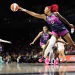 Washington Mystics center Shakira Austin (0) reaches for a loose ball against the Connecticut Sun in the first half at CareFirst Arena.
