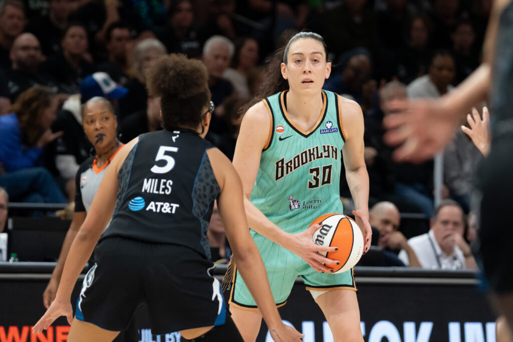 New York Liberty forward Breanna Stewart (30) holds the ball and looks over Minnesota Lynx guard Olivia Miles (5) in the second half during game one of the first round for the 2026 WNBA Playoffs at Target Center.
