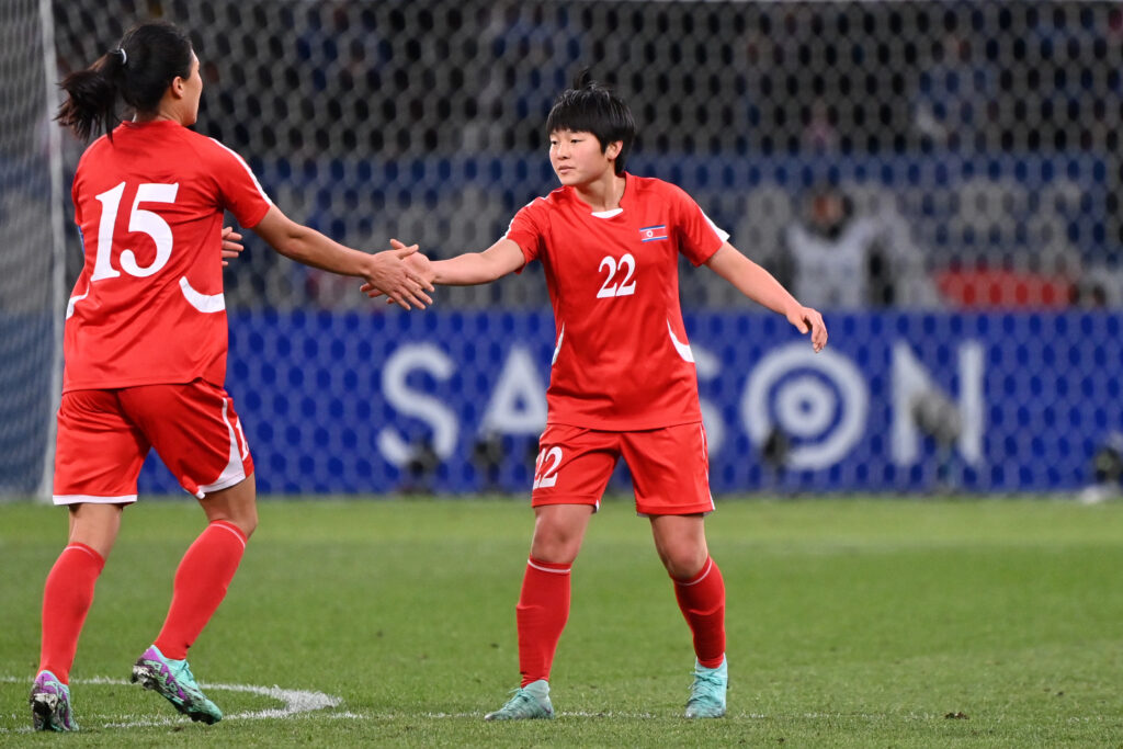 Kim Hye Yong (R) of North Korea celebrates with teammate Wi Jong Sim (L) after scoring the team's first goal during the Women's Football Paris Olympic Asian Final Qualifier second leg between Japan and North Korea at National Stadium on February 28, 2024 in Tokyo, Japan.