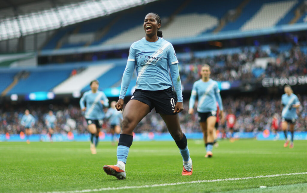 Khadija Shaw of Manchester City celebrates scoring her team's second goal during the Barclays Women's Super League match between Manchester City and Manchester United.