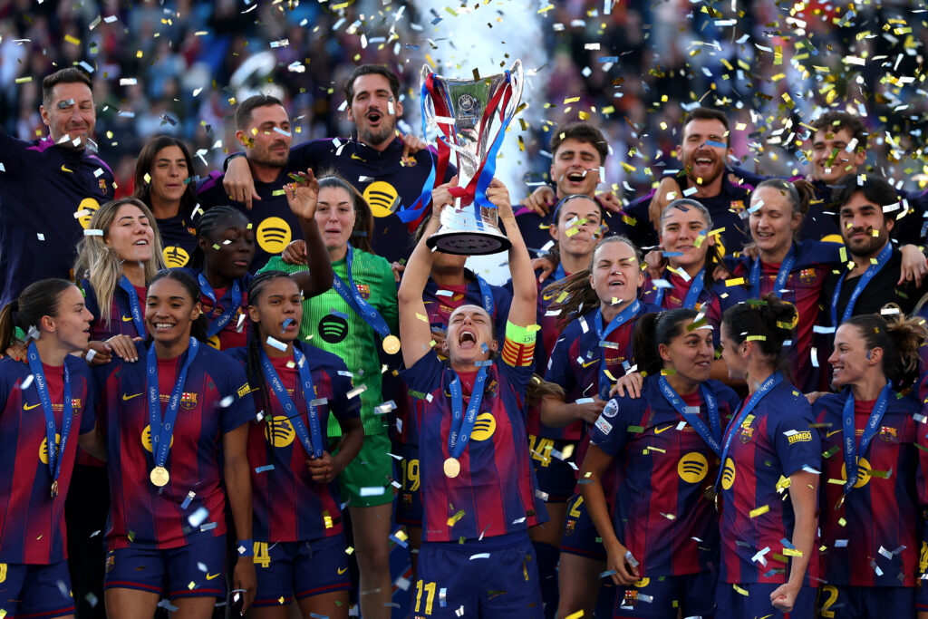 Alexia Putellas of FC Barcelona lifts the UEFA Women's Champions League Trophy as the team celebrates following victory during the UEFA Women's Champions League Final 2026 match between FC Barcelona and OL Lyonnes.