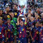 Alexia Putellas of FC Barcelona lifts the UEFA Women's Champions League Trophy as the team celebrates following victory during the UEFA Women's Champions League Final 2026 match between FC Barcelona and OL Lyonnes.