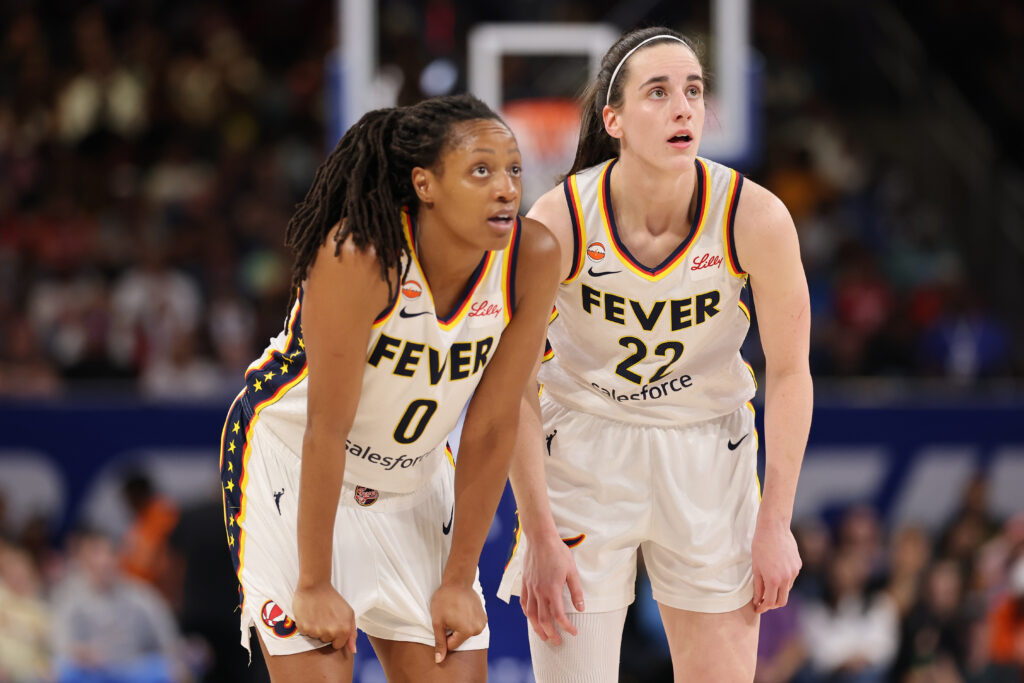 Kelsey Mitchell #0 and Caitlin Clark #22 of the Indiana Fever confer against the Chicago Sky during the first half at Wintrust Arena on August 23, 2026 in Chicago, Illinois.
