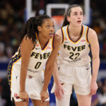 Kelsey Mitchell #0 and Caitlin Clark #22 of the Indiana Fever confer against the Chicago Sky during the first half at Wintrust Arena on August 23, 2026 in Chicago, Illinois.