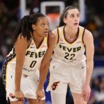 Kelsey Mitchell #0 and Caitlin Clark #22 of the Indiana Fever confer against the Chicago Sky during the first half at Wintrust Arena on August 23, 2026.