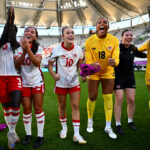 Canada players celebrate after the FIFA U-20 Women's World Cup Round of 16 match between France and Canada at Stadion Miejski LKS Lodz.