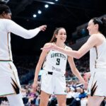 Breanna Stewart #30, Rebecca Allen #9, and Jonquel Jones #35 of the New York Liberty celebrate against the Toronto Tempo during the second half of their WNBA basketball game at the Coca-Cola Coliseum.
