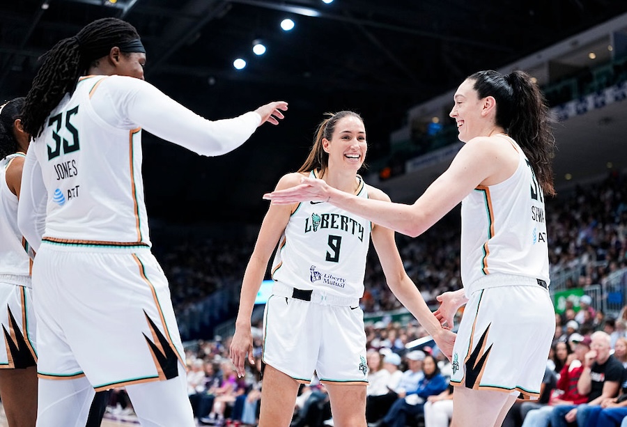 Breanna Stewart #30, Rebecca Allen #9, and Jonquel Jones #35 of the New York Liberty celebrate against the Toronto Tempo during the second half of their WNBA basketball game at the Coca-Cola Coliseum.