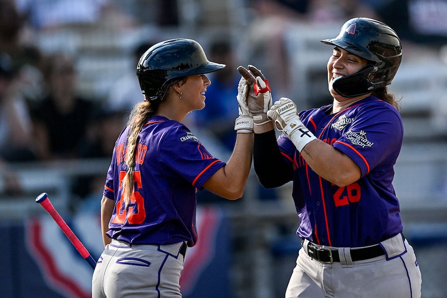 Alexia Jorge #26 of the San Francisco Firebells celebrates with Ela Day-Bedard #25 of the San Francisco Firebells after scoring in the sixth inning of the game against the Los Angeles Queens at Robin Roberts Stadium.