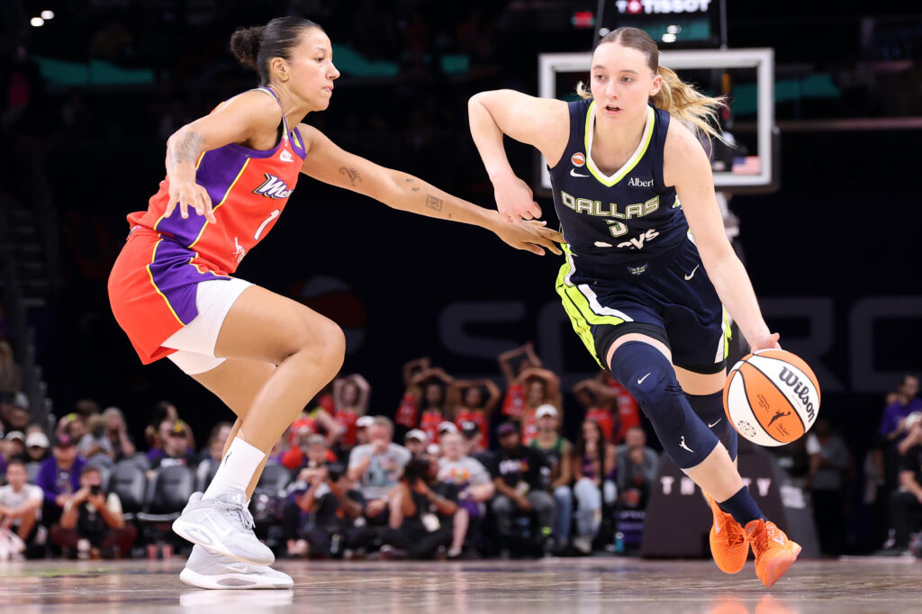 PHOENIX, ARIZONA - SEPTEMBER 21: Paige Bueckers #5 of the Dallas Wings drives to the basket against Noemie Brochant #1 of the Phoenix Mercury during the second half at Mortgage Matchup Center on September 21, 2026 in Phoenix, Arizona.