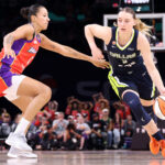 PHOENIX, ARIZONA - SEPTEMBER 21: Paige Bueckers #5 of the Dallas Wings drives to the basket against Noemie Brochant #1 of the Phoenix Mercury during the second half at Mortgage Matchup Center on September 21, 2026 in Phoenix, Arizona.