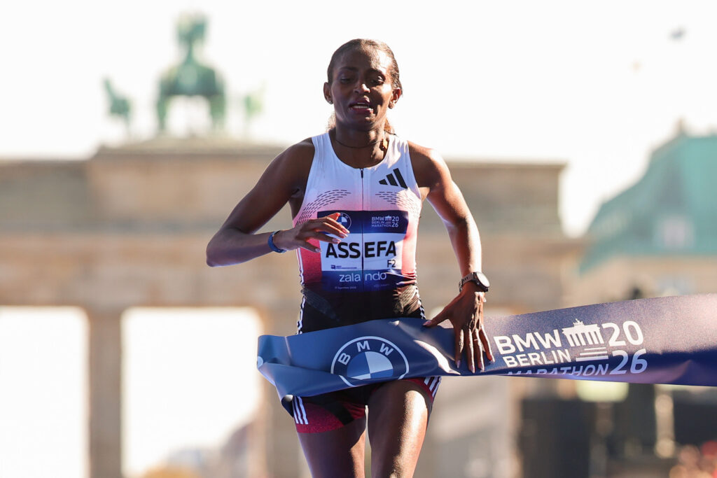 Tigst Assefa from Ethiopia celebrates crossing the line and winning during the 2026 BMW Berlin-Marathon on September 27, 2026 in Berlin, Germany.