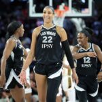 Jackie Young #0, A'ja Wilson #22 and Chelsea Gray #12 of the Las Vegas Aces react after a timeout was called in the fourth quarter of Game One of the 2026 WNBA Playoffs first round against the Indiana Fever.