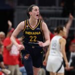 Caitlin Clark #22 of the Indiana Fever celebrates after making a shot in the 99-89 over the Las Vegas Aces during game two of the first round of the WNBA Playoffs at Gainbridge Fieldhouse.