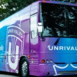 Photo of blue and purple Unrivaled Basketball tour bus.
