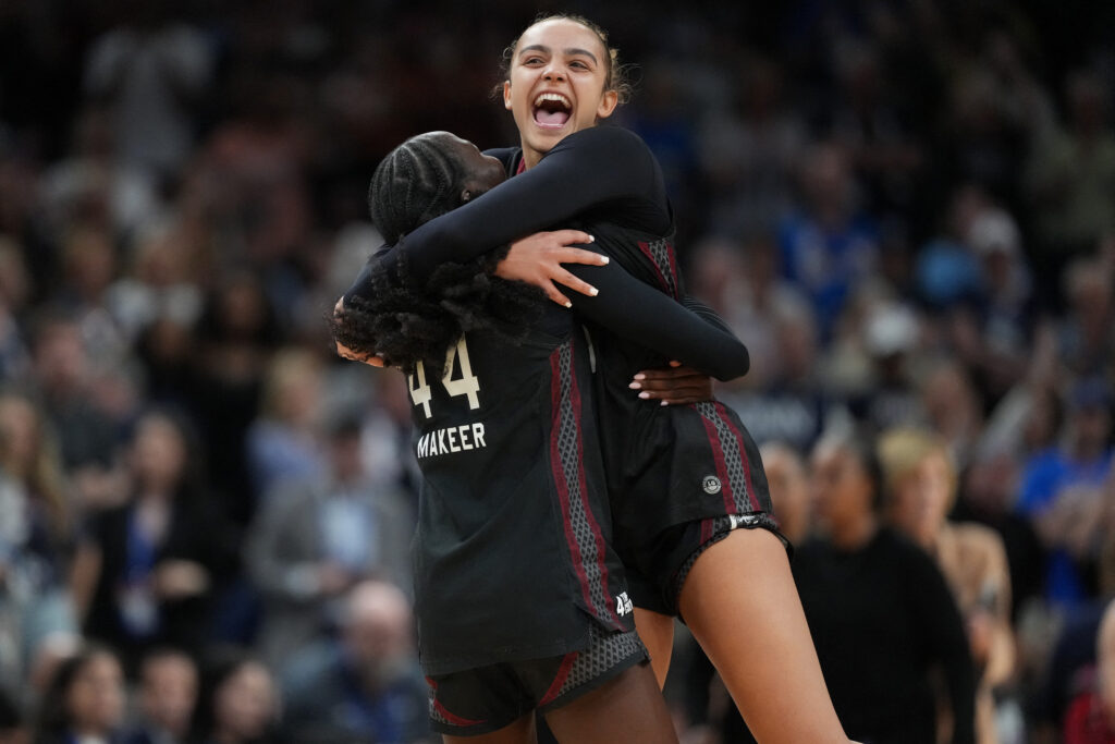 South Carolina Gamecocks guard Agot Makeer (44) and guard Tessa Johnson (5) celebrate after defeating the UConn Huskies in a semifinal of the Final Four of the women's 2026 NCAA Tournament.