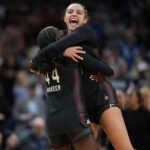 South Carolina Gamecocks guard Agot Makeer (44) and guard Tessa Johnson (5) celebrate after defeating the UConn Huskies in a semifinal of the Final Four of the women's 2026 NCAA Tournament.