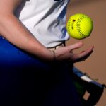 A player flips a softball between innings during an AUSL softball game between the Oklahoma City Spark and the Texas Volts at Oklahoma Christian University, Tuesday, June 9, 2026.