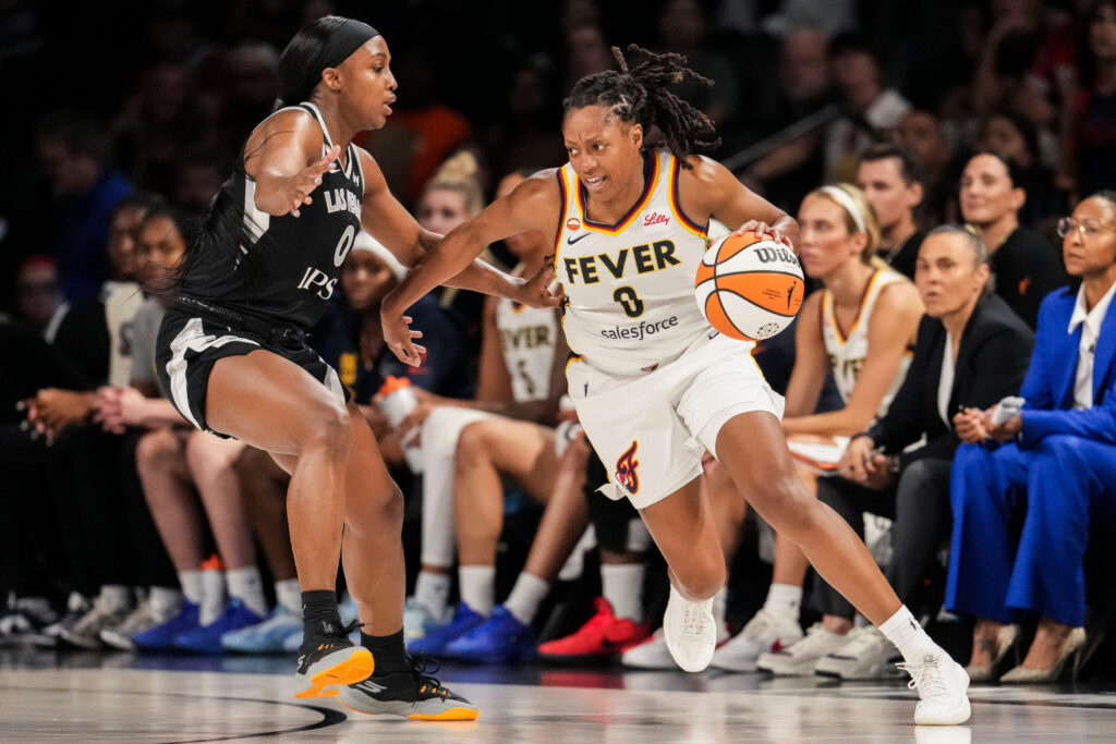 Indiana Fever guard Kelsey Mitchell (0) runs a play against Las Vegas Aces guard Jackie Young (0) on Sunday, Sept. 27, 2026, during the first half of Game 1 of the first round of the WNBA Playoffs at Michelob ULTRA Arena in Las Vegas.