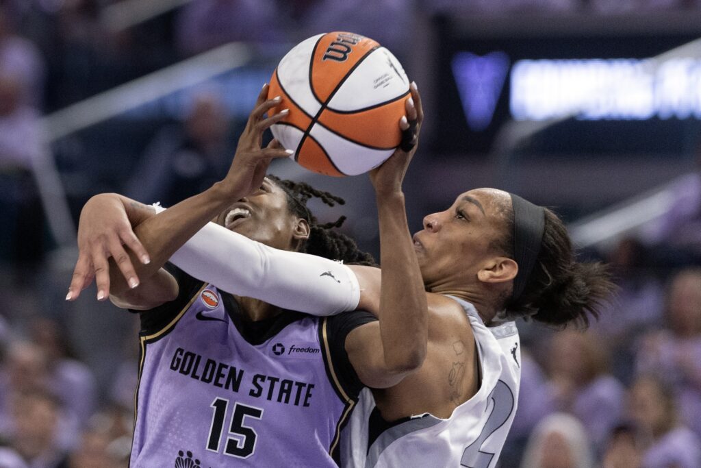 Las Vegas Aces center A'ja Wilson (22) fouls Golden State Valkyries guard Tiffany Hayes (15) as she drives to the basket during the second quarter of game one of the second round for the 2026 WNBA Playoffs at Chase Center.