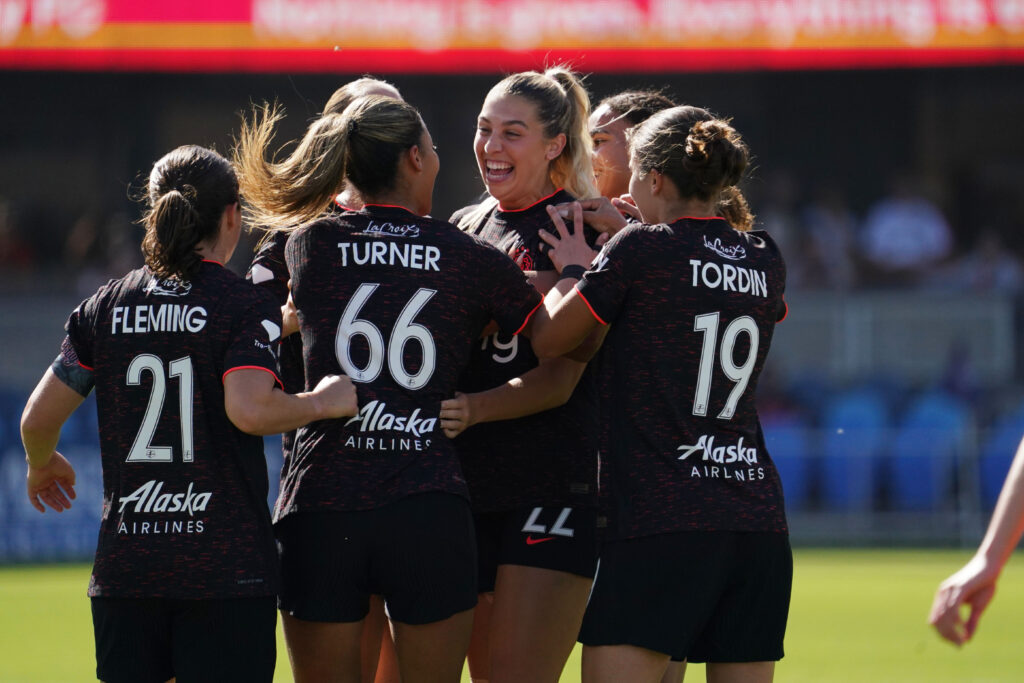 Portland Thorns midfielder Morgan Weaver (22) celebrates with forward Reilyn Turner (66) and the team after scoring a goal in the first half at PayPal Park.