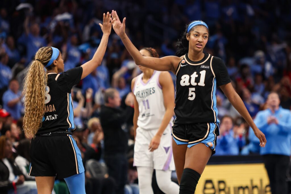 Atlanta Dream guard Jordin Canada (3) and forward Angel Reese (5) high five against the Golden State Valkyries in the fourth quarter during game three of the 2026 WNBA Finals at State Farm Arena.