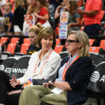 Indiana Fever President of Basketball and Business Operations Kelly Krauskopf (left) and Indiana Fever Chief Operating Officer and General Manager Amber Cox (right) interact before a WNBA game between the Indiana Fever and the Connecticut Sun.