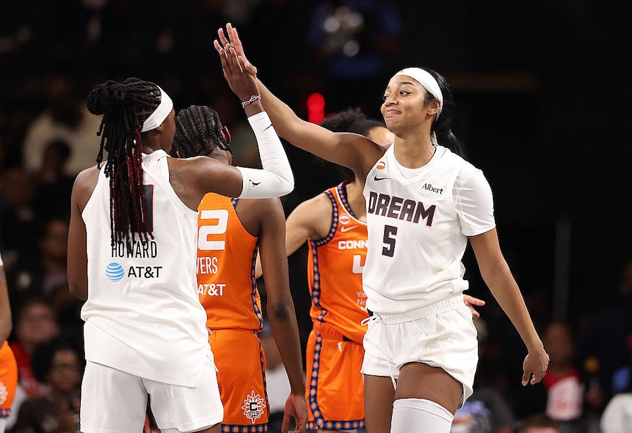 Angel Reese #5 of the Atlanta Dream reacts with Rhyne Howard #10 after drawing a foul against the Connecticut Sun during the second quarter at Gateway Center Arena.