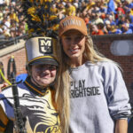 WNBA star and Missouri Tigers alumni Sophie Cunningham poses for a picture with a marching band member before an SEC football game between the Florida Gators and Missouri Tigers.