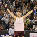 Czech Republic's Karolina Muchova celebrates after beating Japan's Naomi Osaka in their women's singles match at the China Open tennis tournament in Beijing.