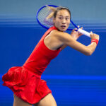 Qinwen Zheng of China in action against Alina Charaeva of Armenia in the fourth round on Day 8 of the China Open at National Tennis Center.