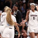 Angel Reese #5 of the Atlanta Dream reacts with Naz Hillmon #00 and Jordin Canada #3 after drawing a foul on a basket against the New York Liberty during the fourth quarter of game one of the semifinals of the WNBA playoffs.