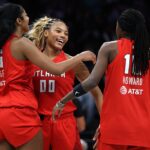 Naz Hillmon #00, Angel Reese #5, and Rhyne Howard #10 of the Atlanta Dream celebrate after defeating the New York Liberty in game three of the SemiFinals of the WNBA Playoffs at Barclays Center.