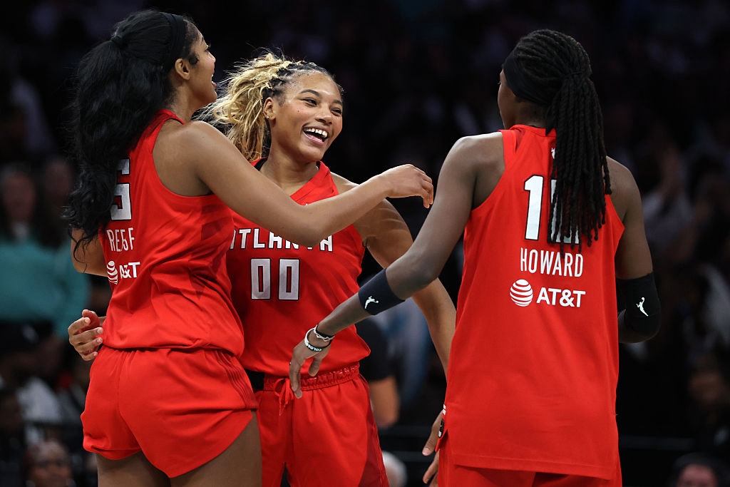 Naz Hillmon #00, Angel Reese #5, and Rhyne Howard #10 of the Atlanta Dream celebrate after defeating the New York Liberty in game three of the SemiFinals of the WNBA Playoffs at Barclays Center.