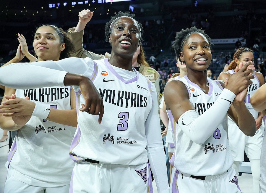 Janelle Salaun #13, Laeticia Amihere #3 and Kaila Charles #6 of the Golden State Valkyries celebrate on the court after the team's 87-77 overtime victory over the Las Vegas Aces in Game Three of the 2026 WNBA Playoffs.