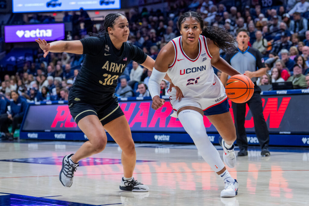 Sarah Strong #21 of the Connecticut Huskies is defended by Kya Smith #30 of the Army Black Knights during the first half of an NCAA women's exhibition basketball game.