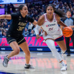 Sarah Strong #21 of the Connecticut Huskies is defended by Kya Smith #30 of the Army Black Knights during the first half of an NCAA women's exhibition basketball game.